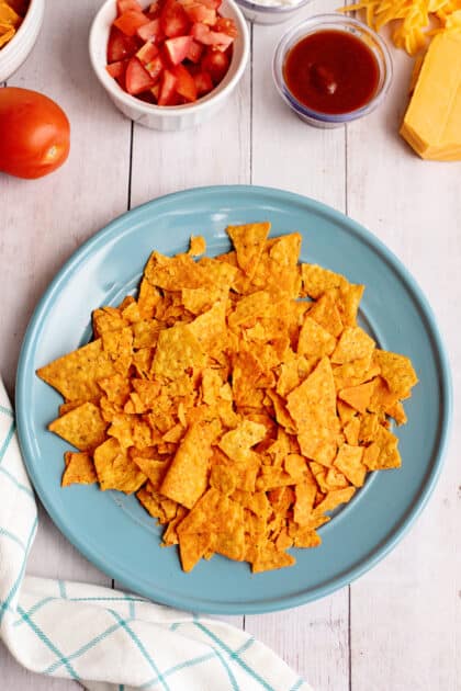 Place crushed Doritos on plate.