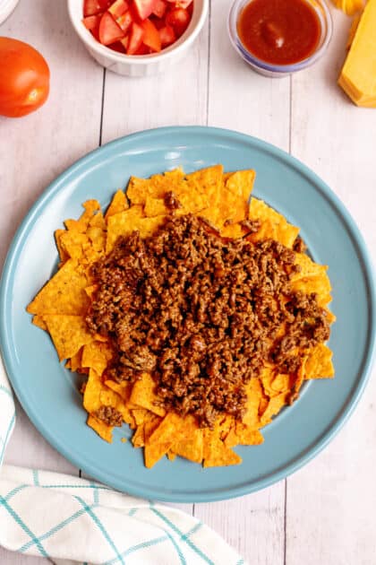 Top crushed Doritos with ground beef.