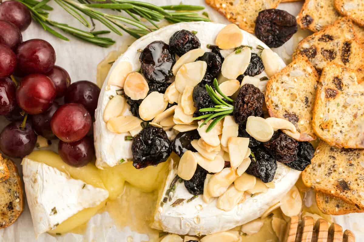 Baked brie with honey, almonds, cherries, and rosemary.