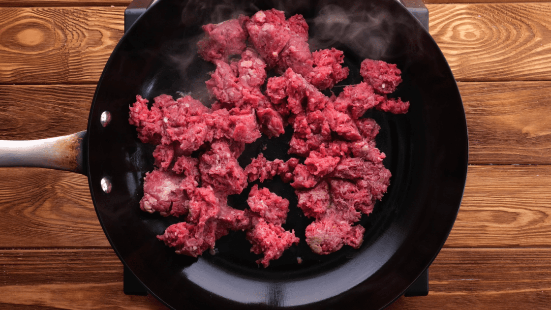 Cook ground beef in skillet.