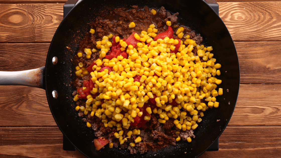 Add drained corn to skillet.