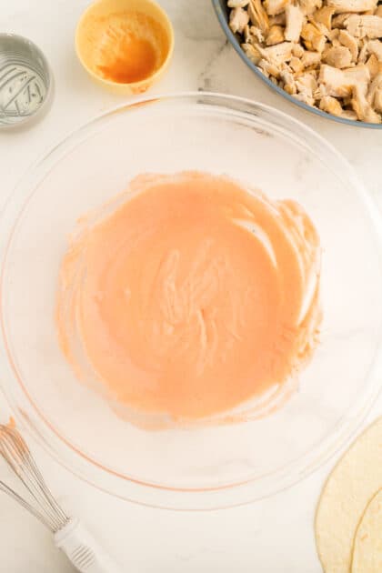 Combine cream cheese and hot sauce in mixing bowl.