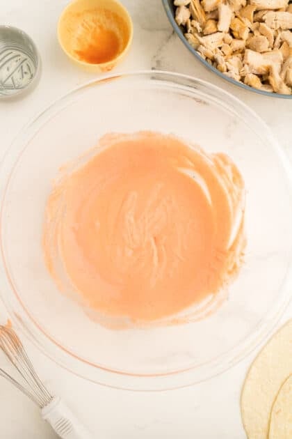 Combine cream cheese and hot sauce in mixing bowl.