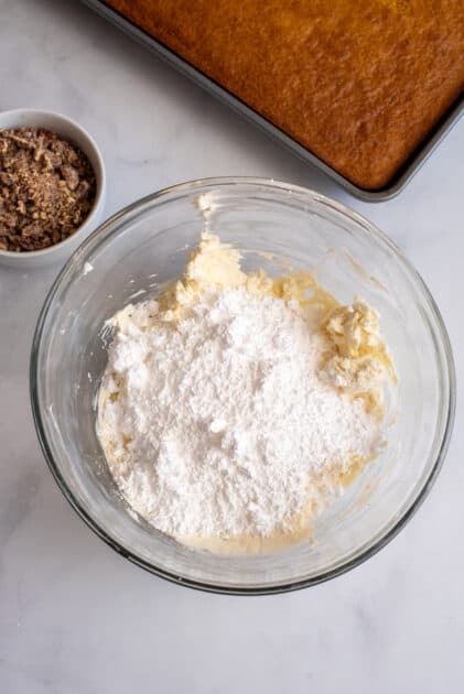 Add confectioners' sugar to mixing bowl