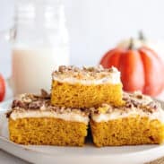 Stack of pumpkin bars with cream cheese frosting.
