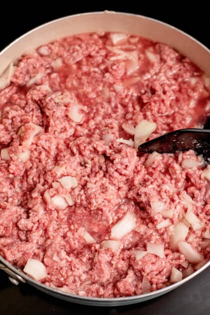 Start combining ground beef and water in skillet.