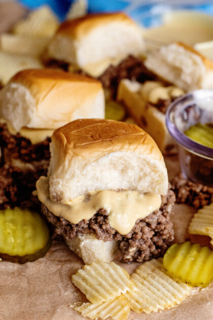 Loose meat sandwiches surrounded by pickle slices.