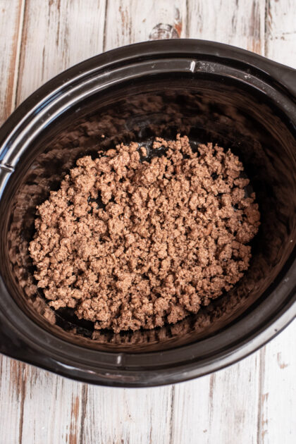 Add browned ground beef to crockpot.