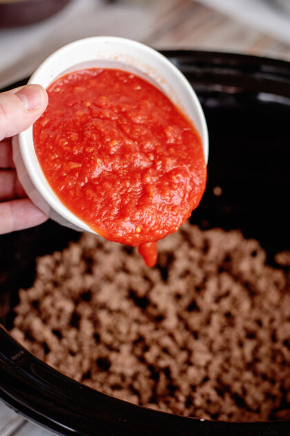 Add crushed tomatoes to crockpot.