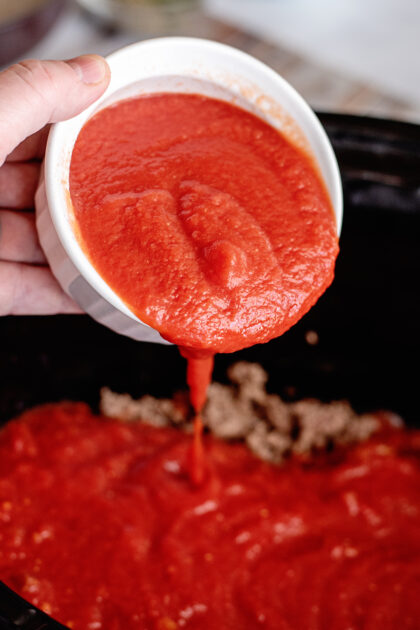 Add tomato sauce to crockpot.