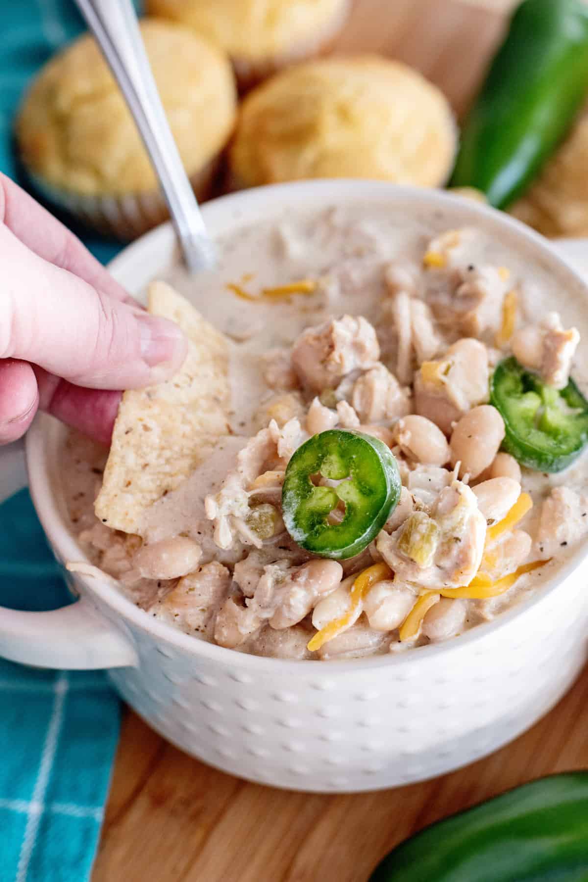 Scooping up white bean chili with tortilla chip.