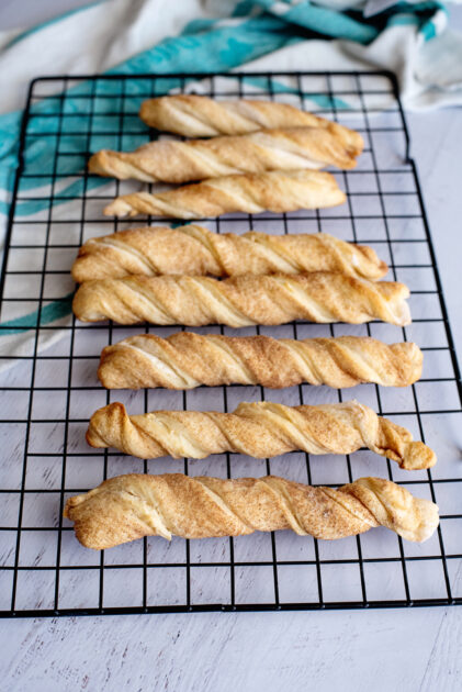 Baked cinnamon twists on wire rack.