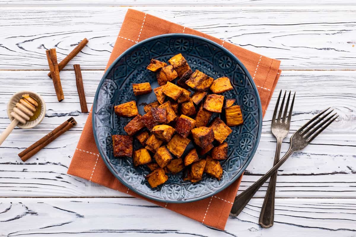 Plate of honey roasted sweet potato with cinnamon.