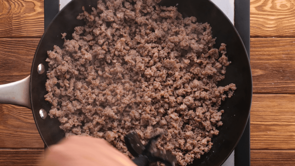 Cook sausage in skillet.