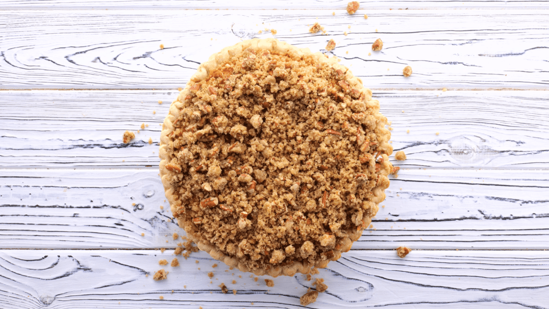 Add streusel topping to baked pie.