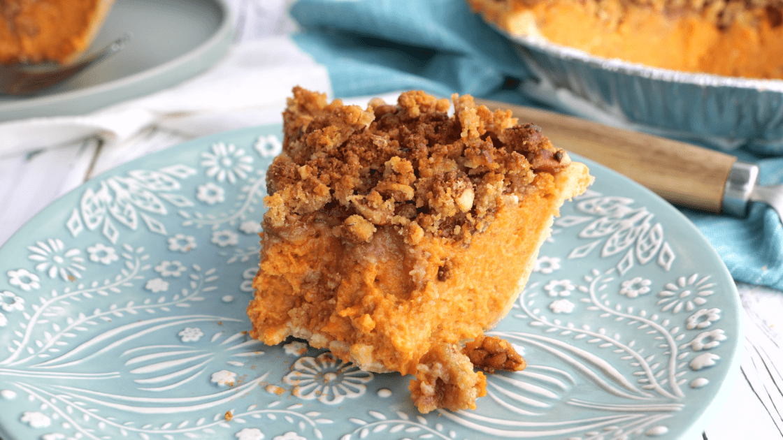 Forkful missing from piece of sweet potato pie.