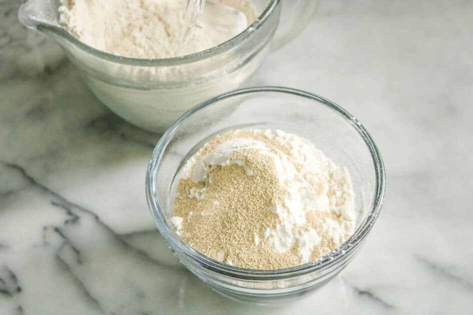 Add flour and yeast to wet ingredients in mixing bowl.