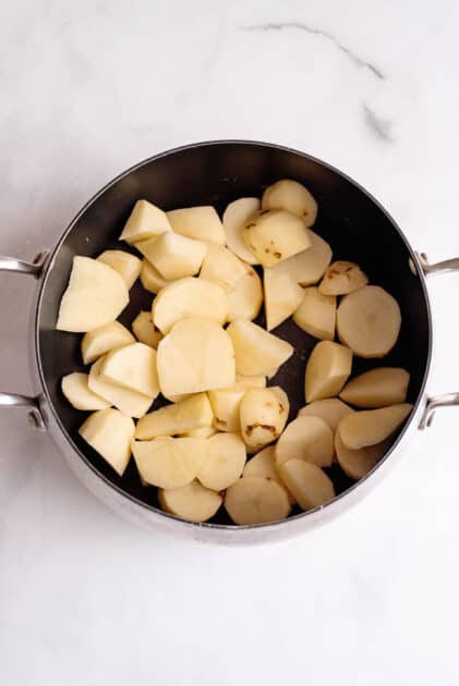 Place peeled and sliced potatoes in pot.