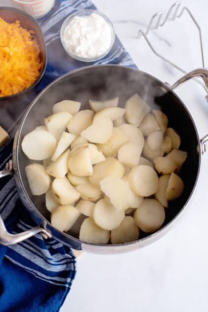 Cover potatoes with water and cook until tender.