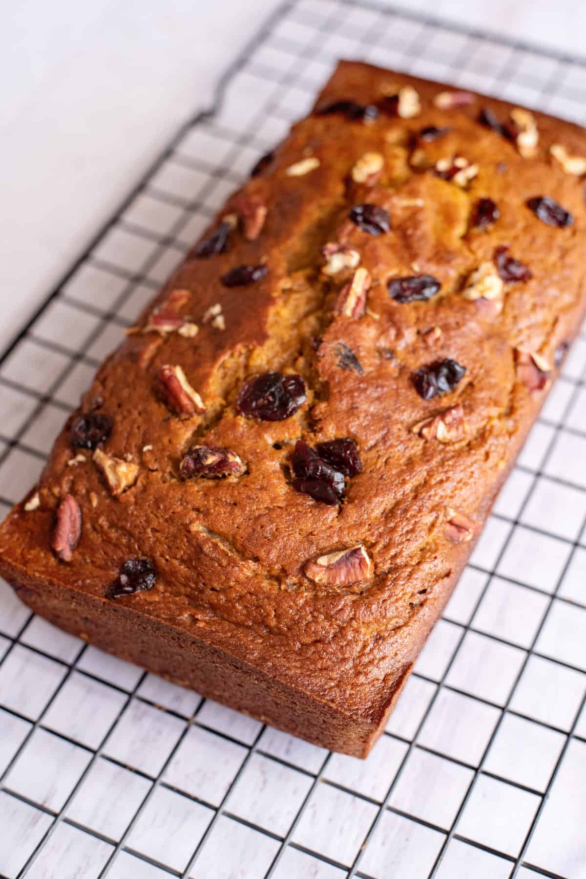 cool pumpkin cranberry bread on wire rack 