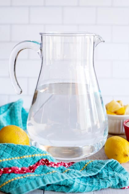 A pitcher filled halfway with water.