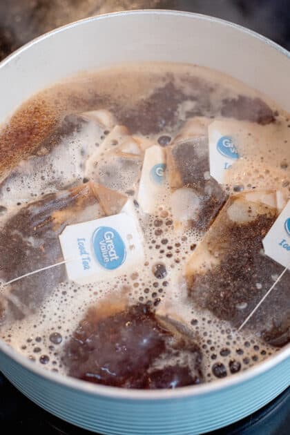 Tea brewing in a pot of boiling water.