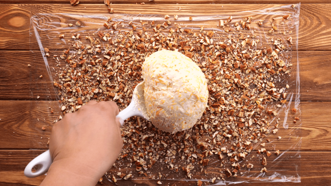 Dump cheese ball on top of pecans.