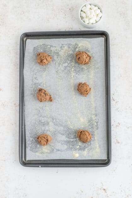 Place cookie dough balls on prepared baking sheet.