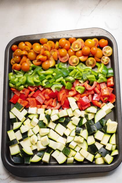 Place vegetables and seasonings on baking sheet.
