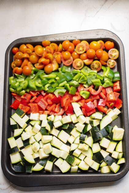 Place vegetables and seasonings on baking sheet.