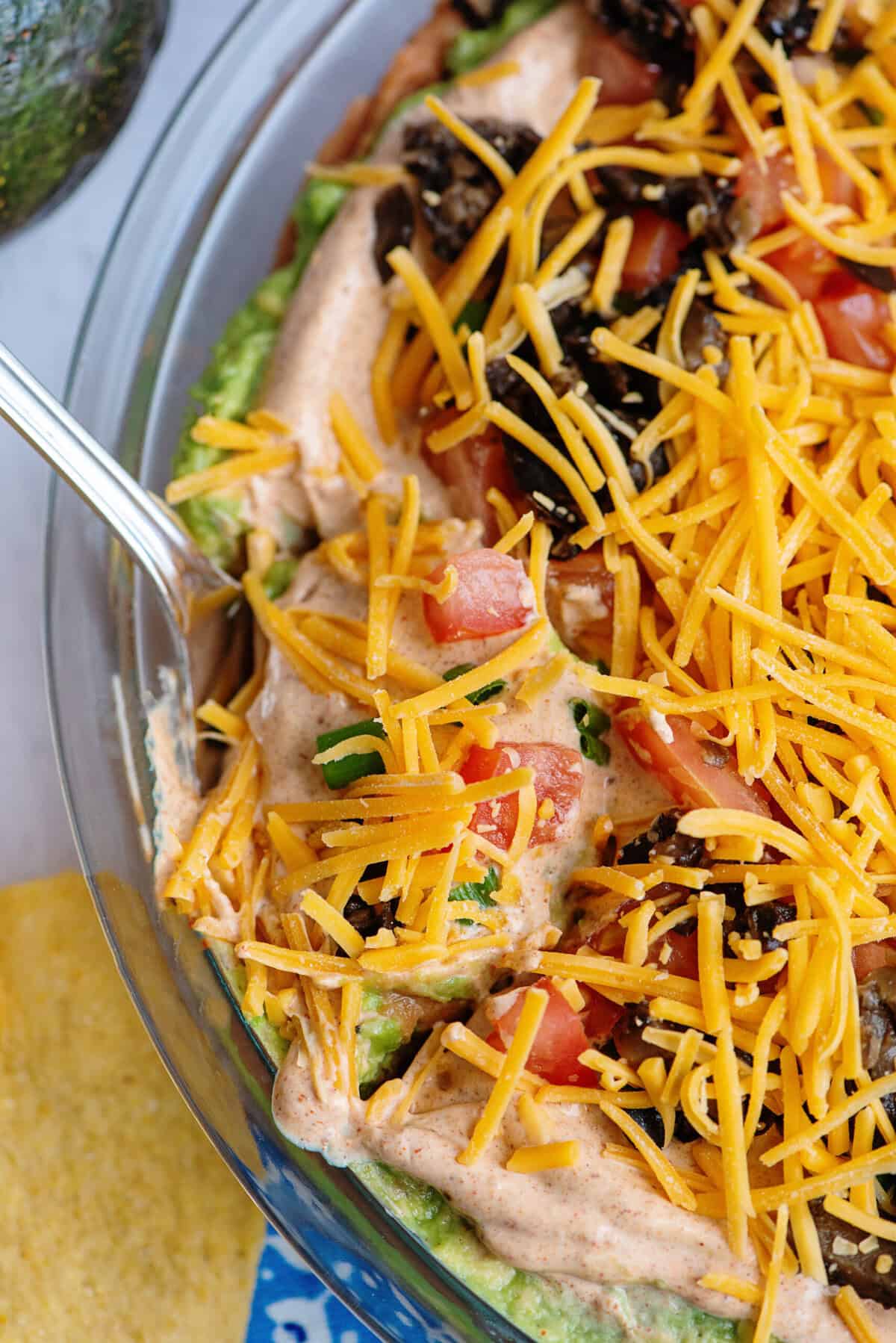 Tex Mex dip with a spoon inside.