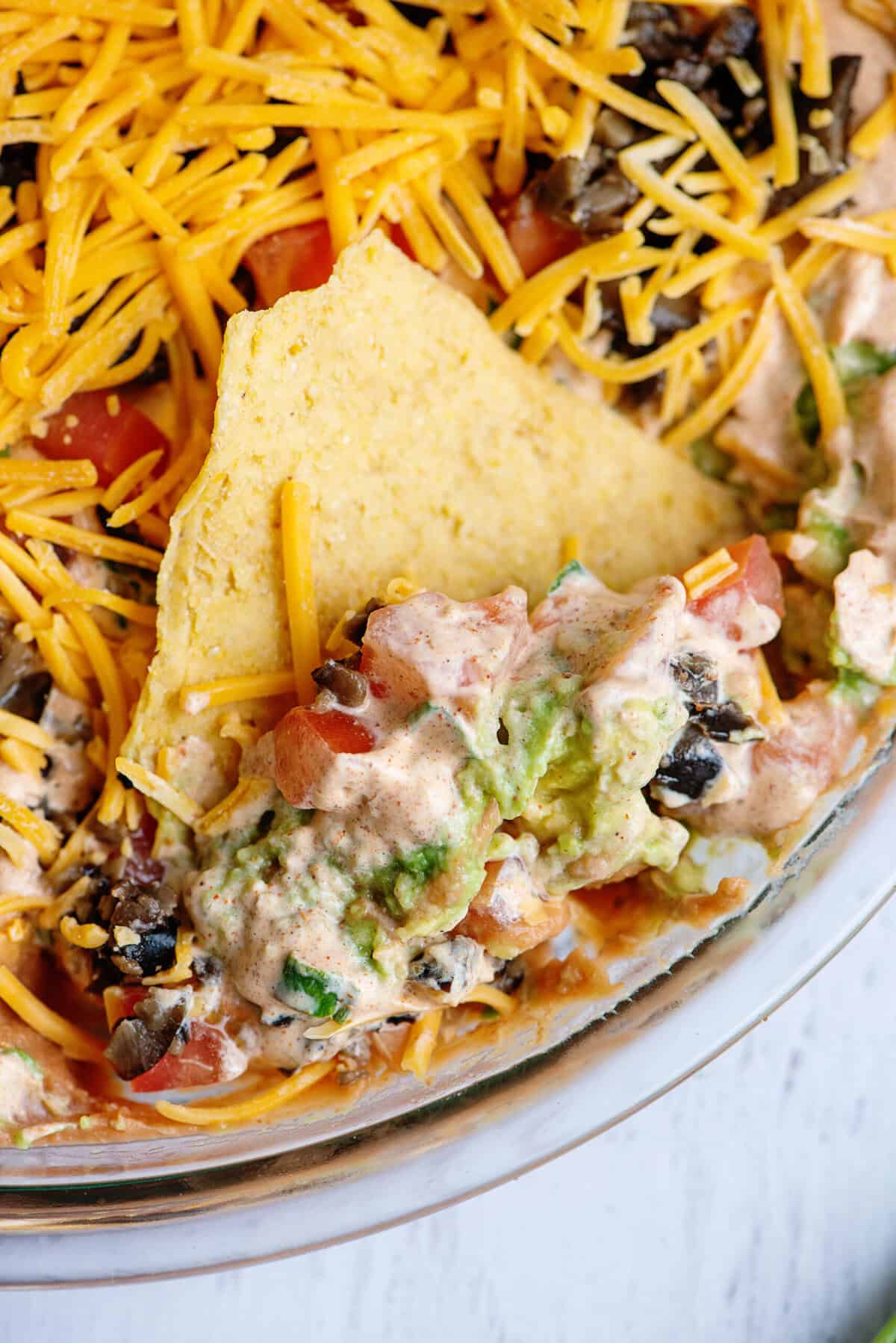 Close-up of a chip scooping out Tex Mex dip.