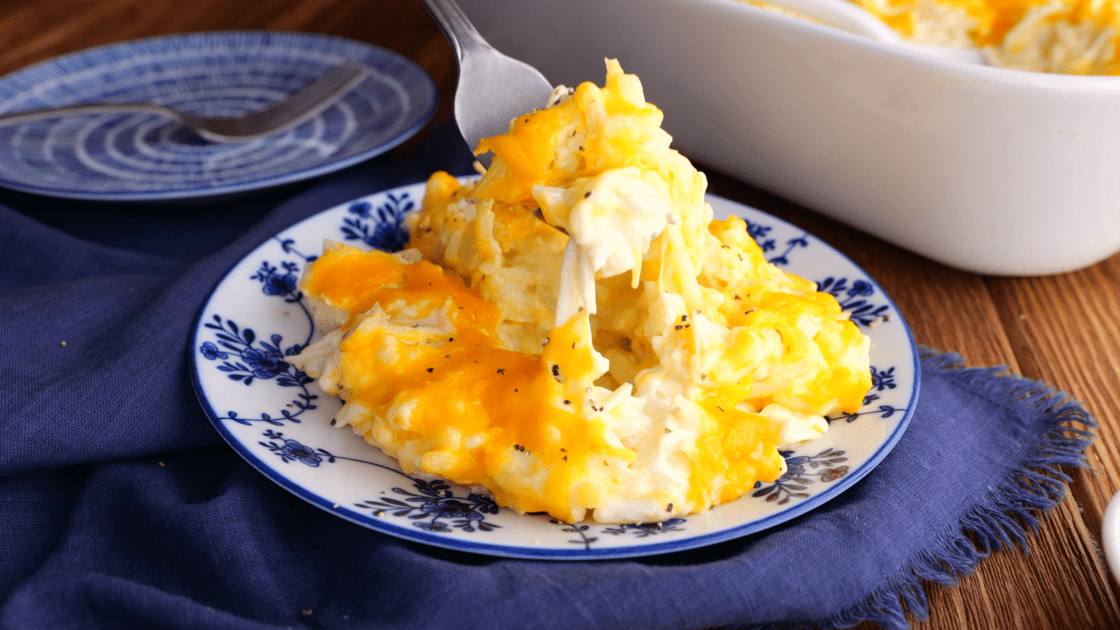 Forkful of cheesy hashbrown casserole.