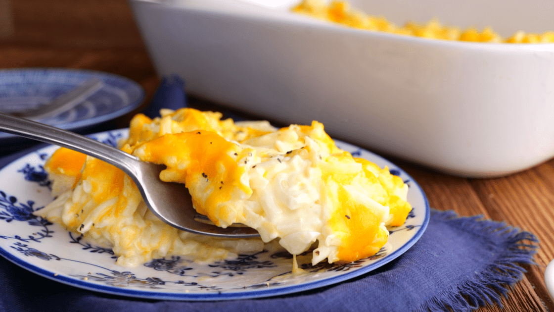 Forkful of cheesy hashbrown casserole.