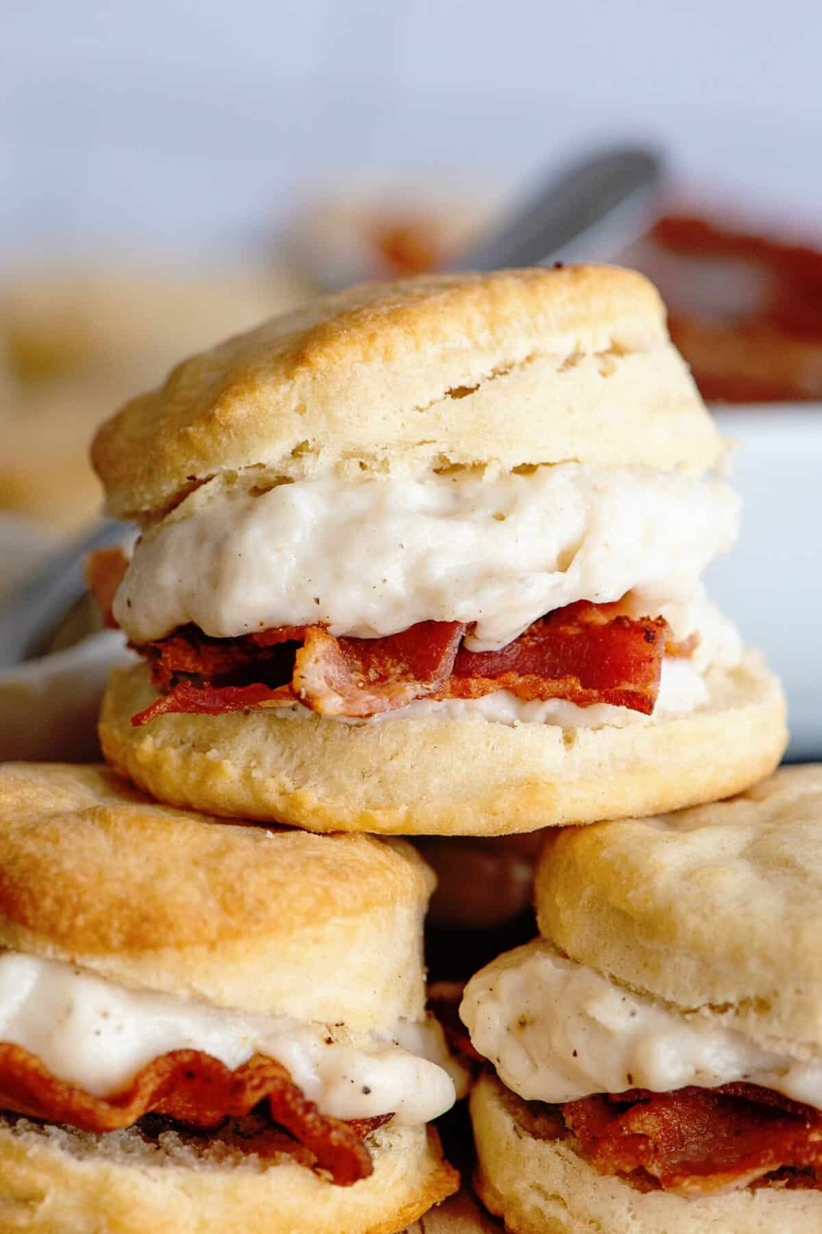 Close-up of stacked biscuits and bacon gravy.
