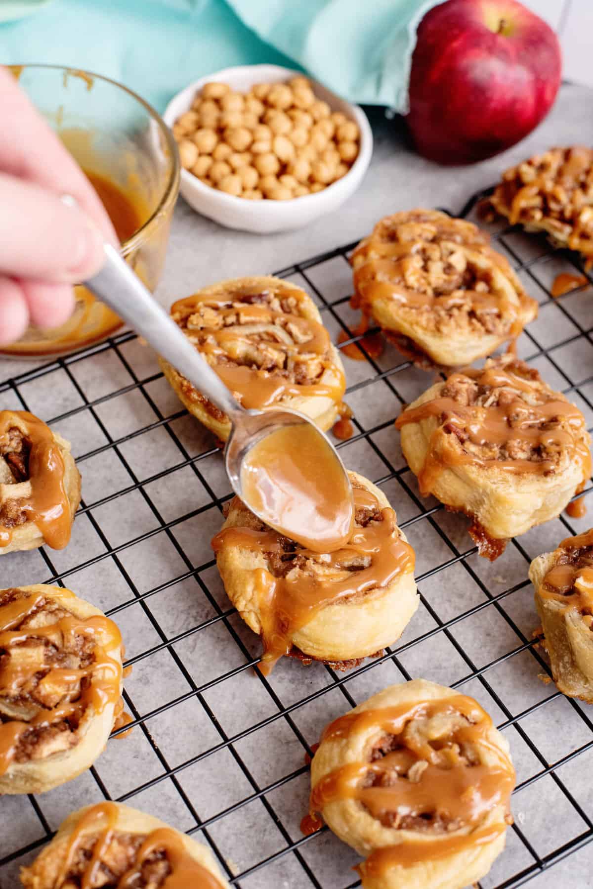 drizzle caramel over apple pinwheels with a spoon