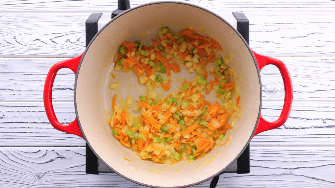 Softened vegetables in saucepan.