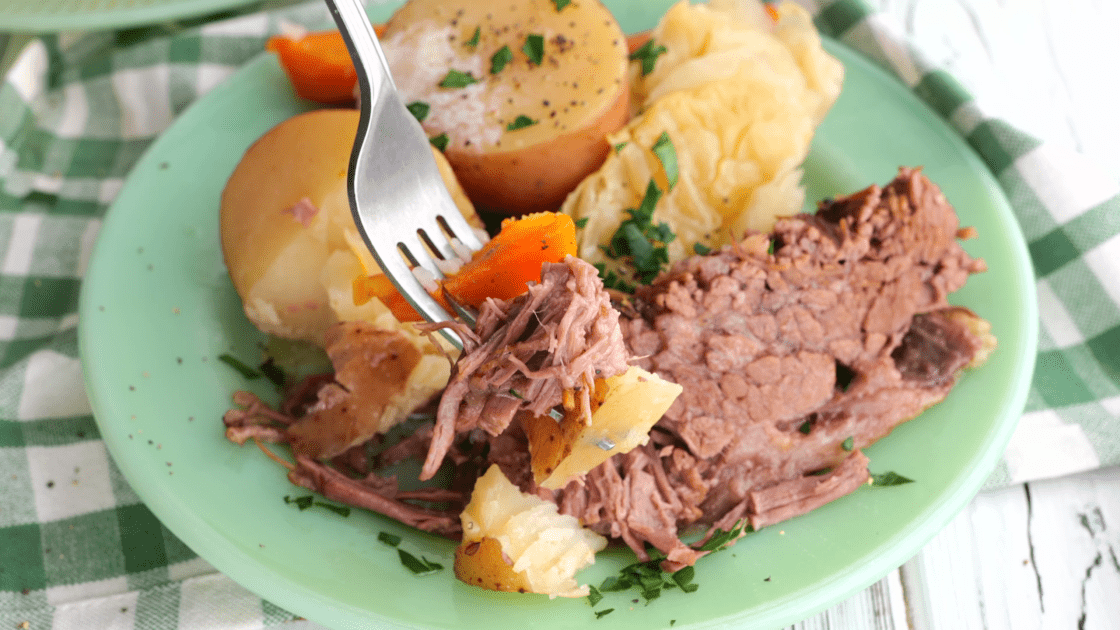 Forkful of crock pot corned beef with vegetables.