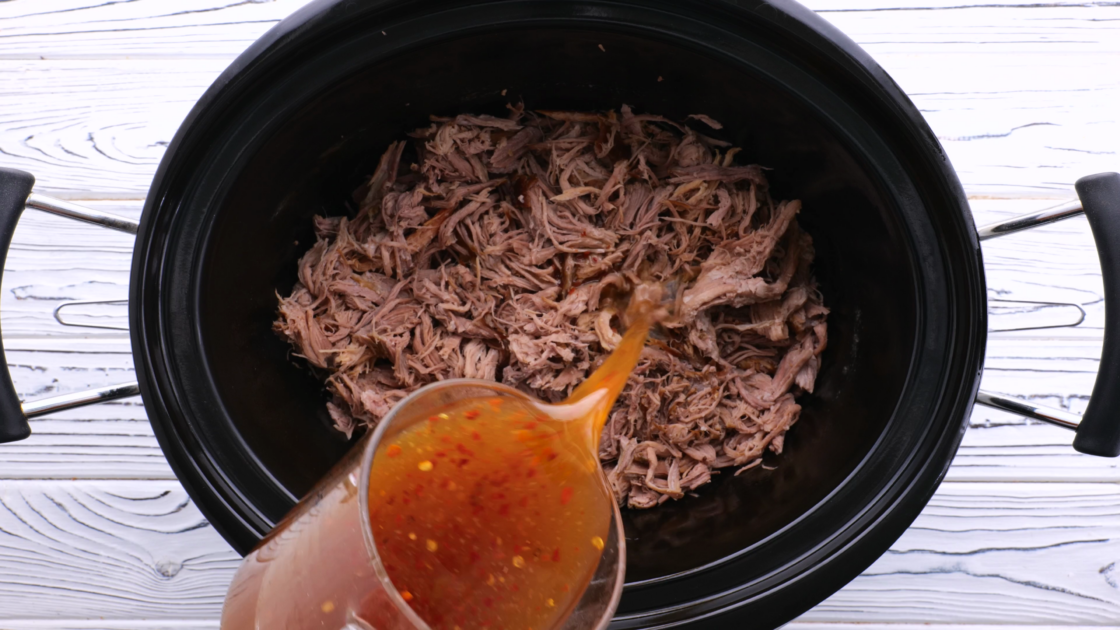 Pour sauce over pulled pork in slow cooker.