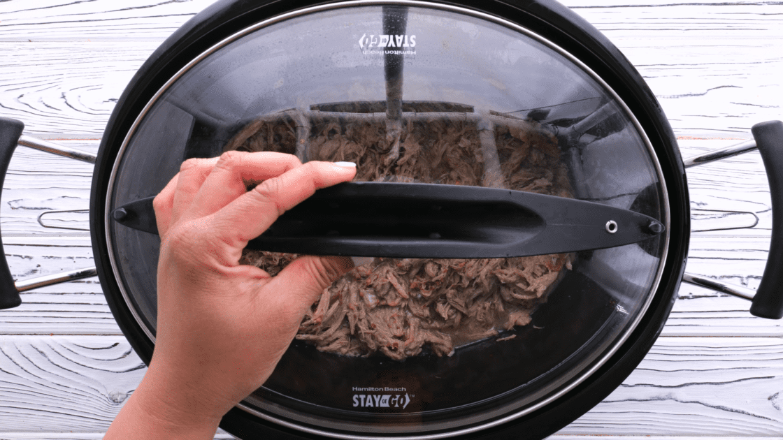 Place lid on the pulled pork in the slow cooker.