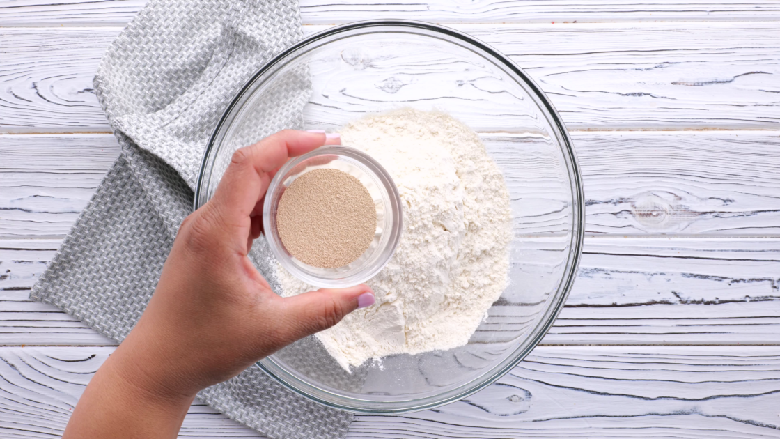 Add yeast to mixing bowl.