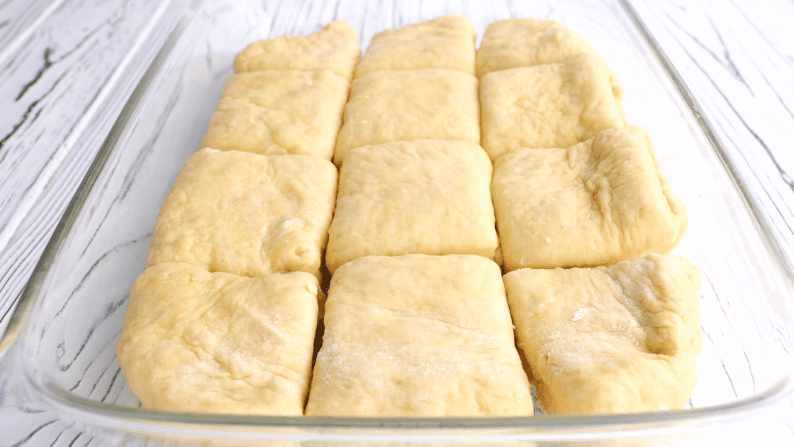 Place yeast rolls into greased baking dish.