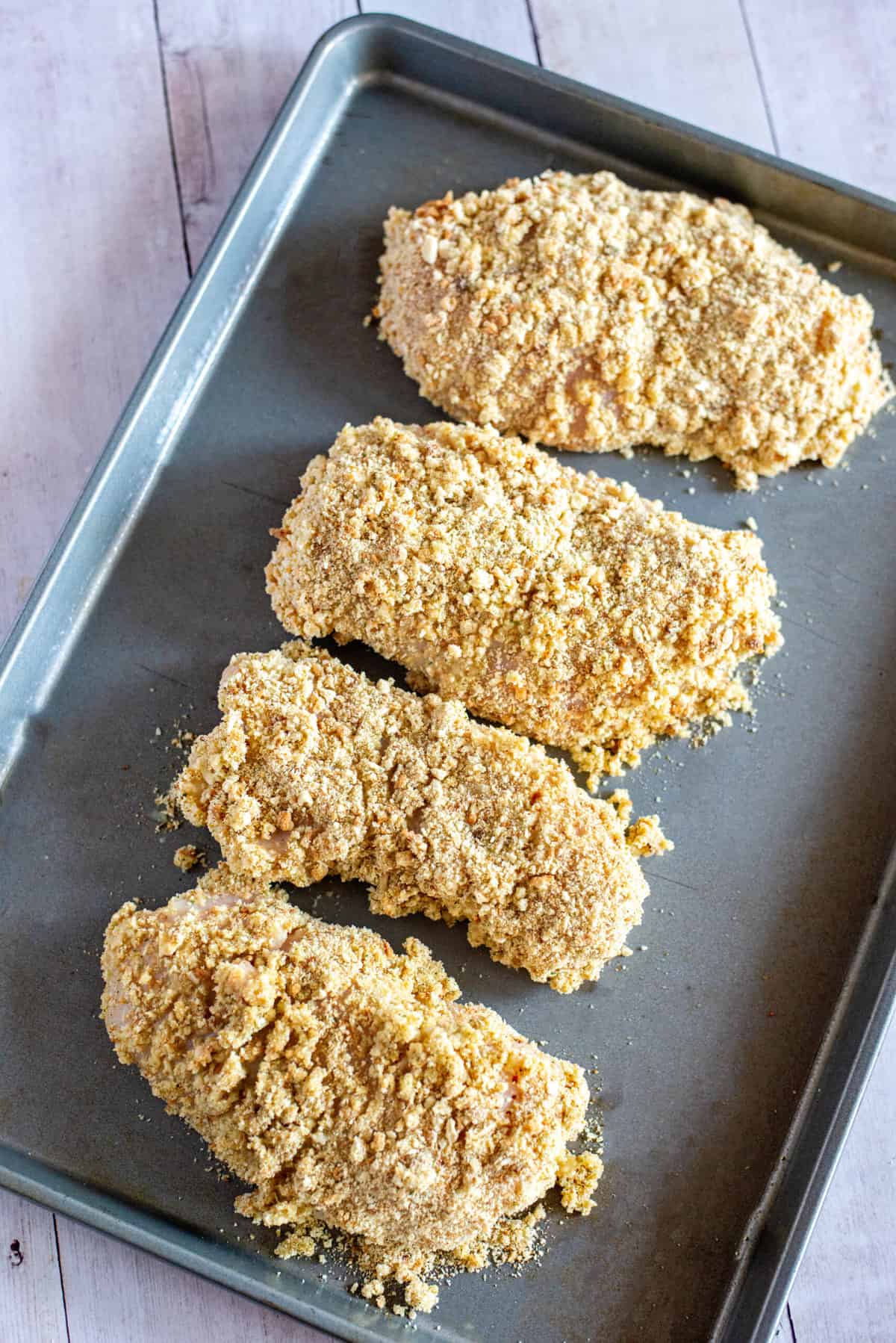 place stuffing-coated chicken on a baking sheet