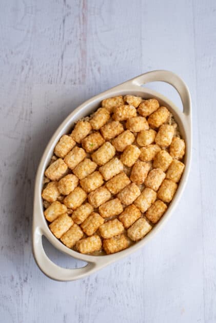 Top chicken mixture with frozen tater tots.