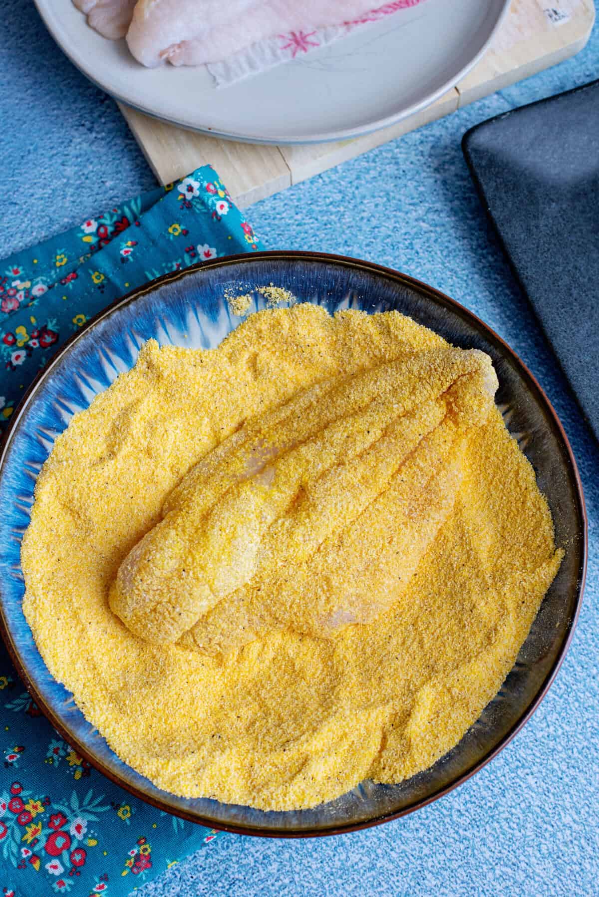 Dredging catfish in cornmeal.