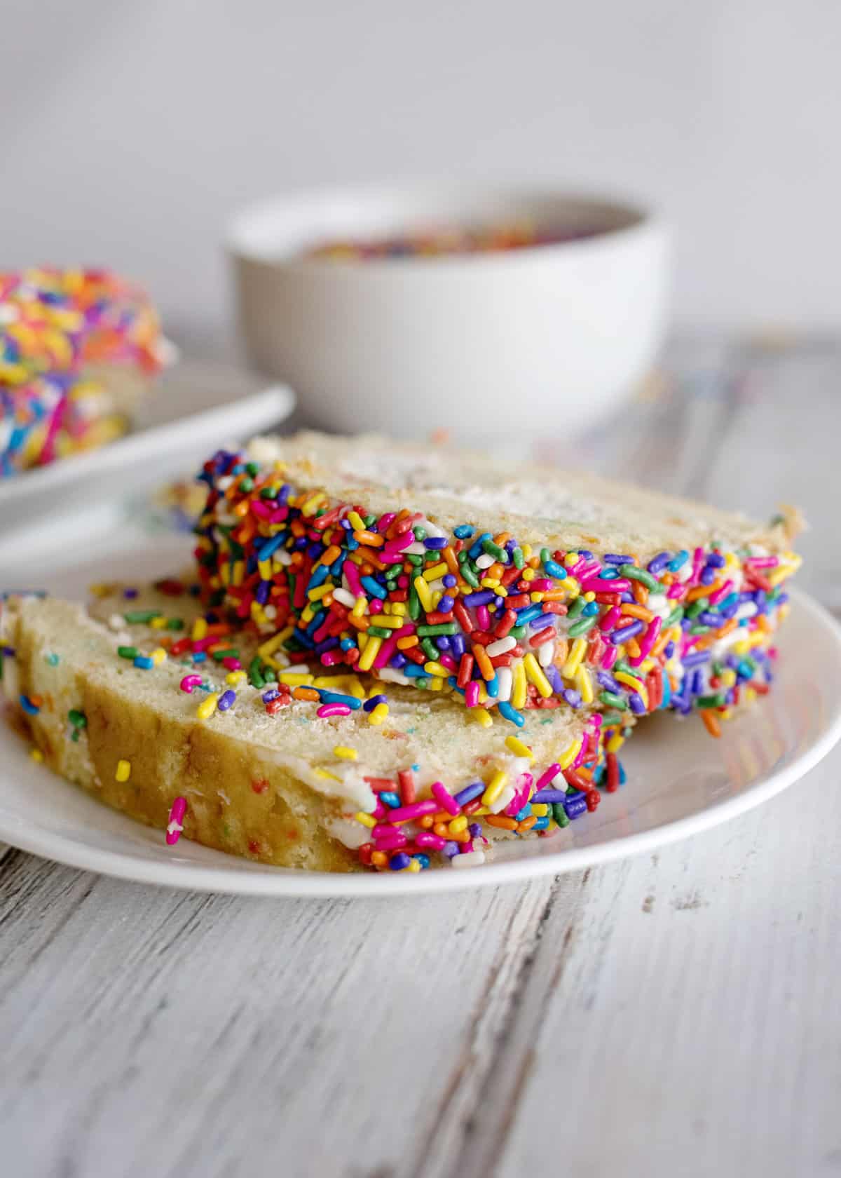 Slices of birthday cake roll on a plate.