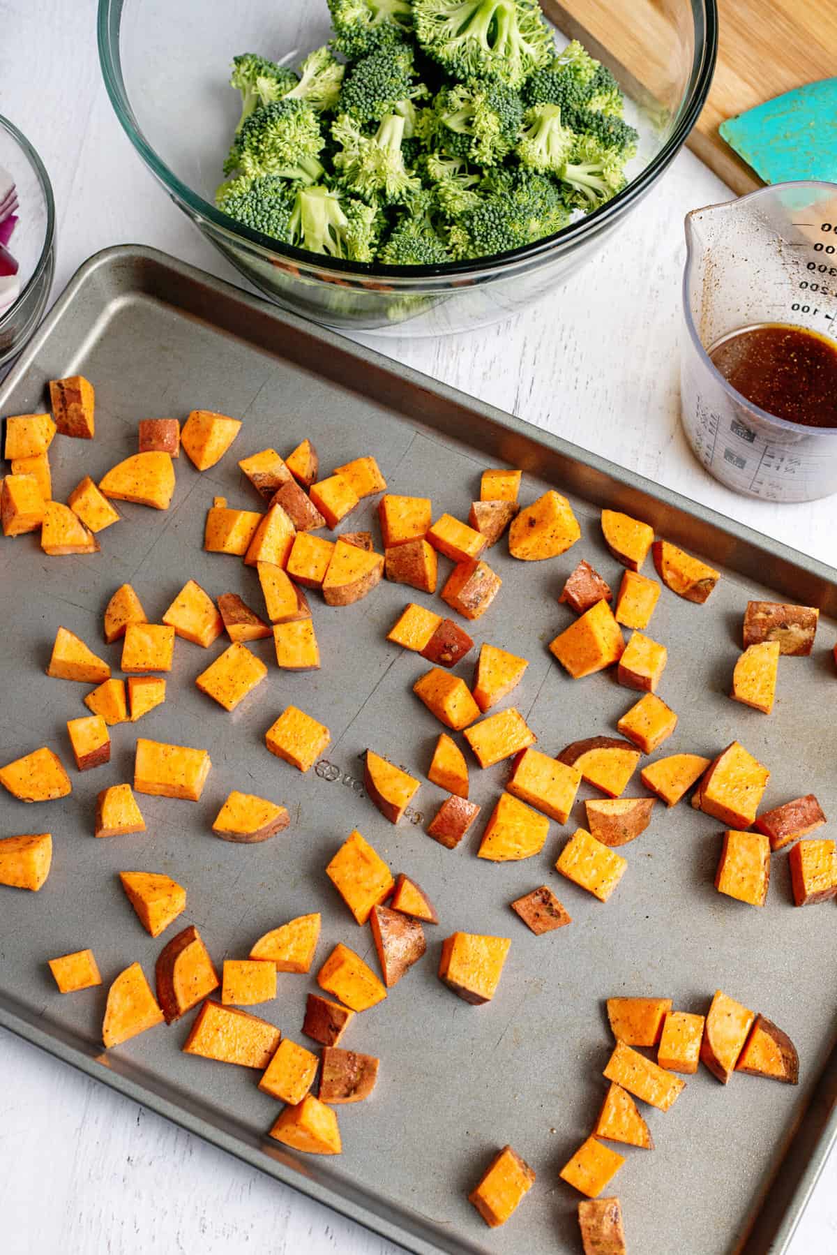 spread sweet potatoes on prepped baking sheet