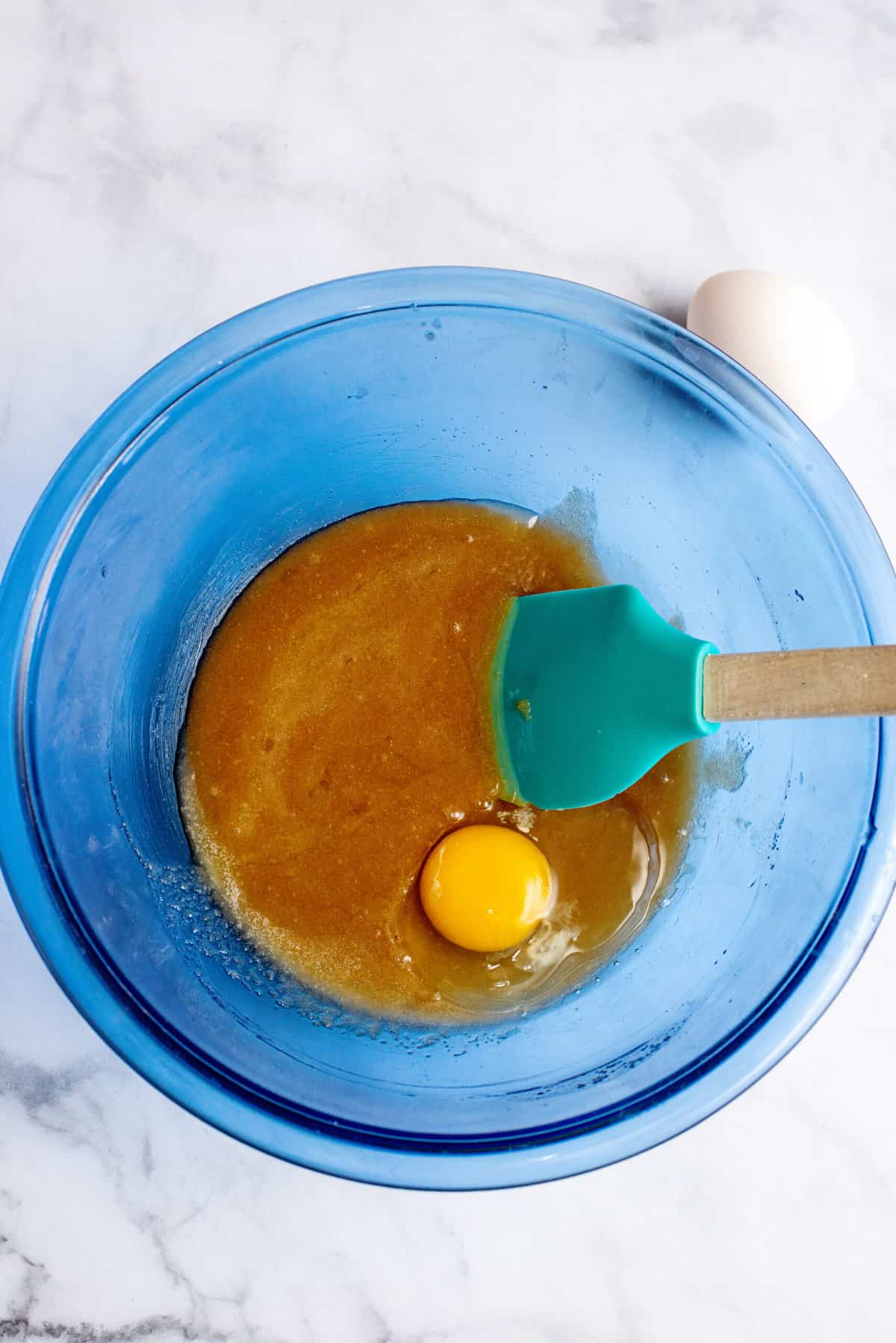 Add in the eggs, one at a time, and mix between each one. 