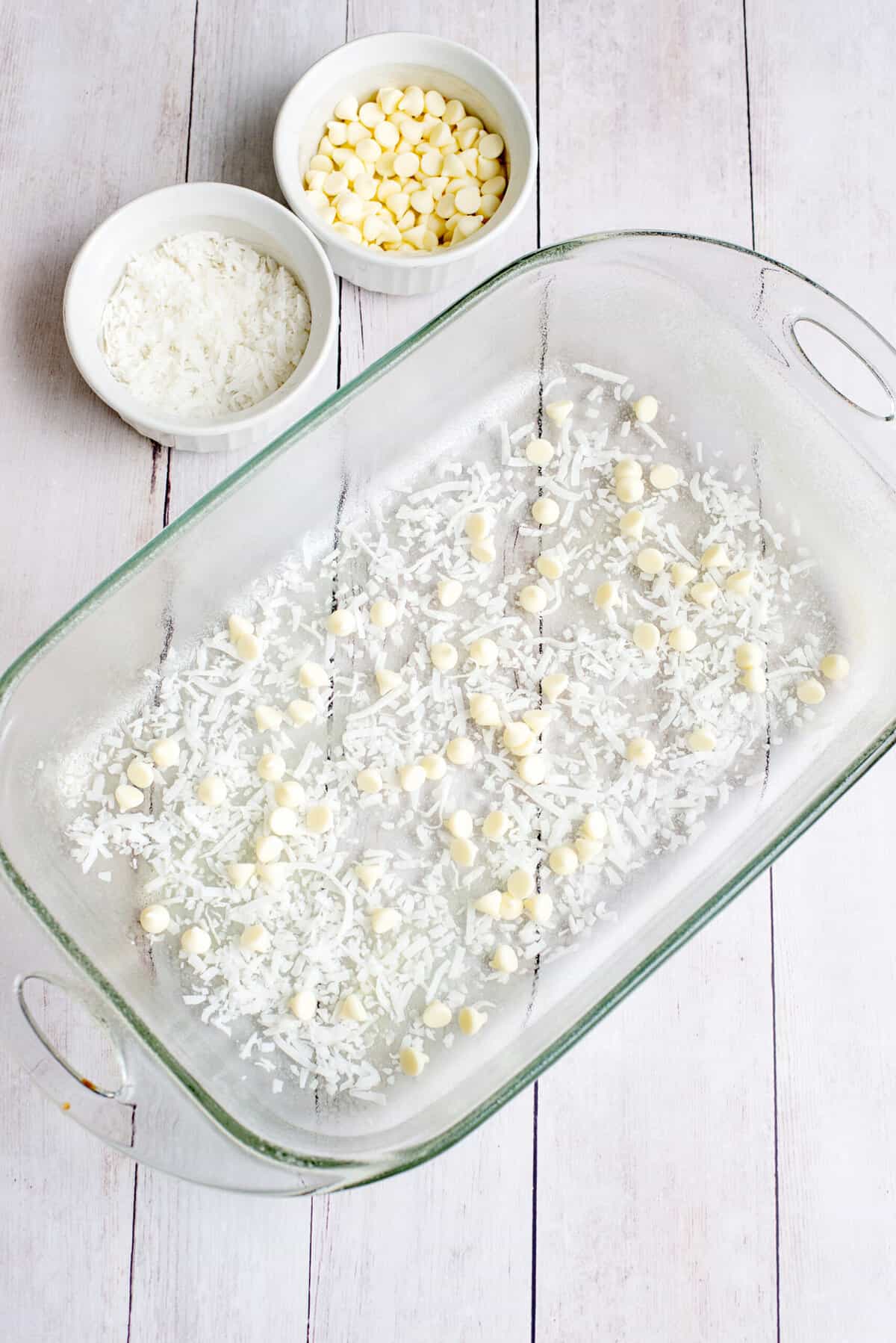 layer coconut and vanilla chips on the bottom of the pan