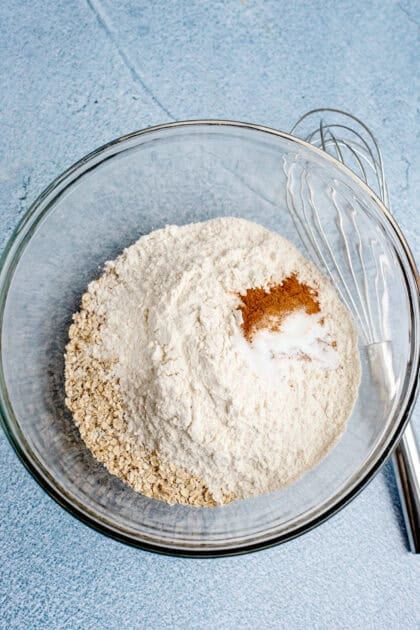 Dry ingredients for oatmeal cream pie cookie dough in a glass bowl.